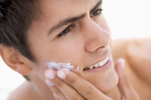 Man putting on shaving cream smiling